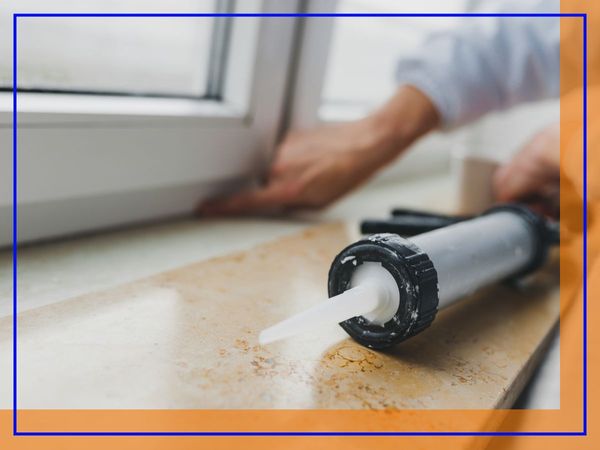 Caulking gun next to window